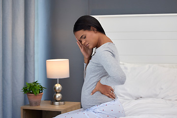Image showing Pregnant, headache and back pain of a woman in her home bedroom thinking about stress or anxiety. Person on bed with fatigue, insomnia and mental health depression or stress in pregnancy in morning