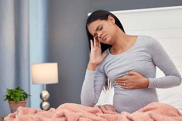 Image showing Pregnancy, headache and woman in bed, pain and stress with maternity issues, anxiety and touching stomach. Pregnant, female and lady with ache, migraine and contractions in bedroom and frustrated