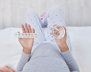 Image showing Pregnant, medicine and water in woman hands above pills box for health, growth and wellness. Person in home bedroom with a glass and Pharma product container for pregnancy supplement and development