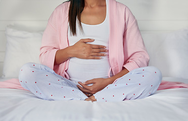 Image showing Pregnant, hands on stomach and woman in bed holding belly for baby, infant and affection at home. Pregnancy love, family and excited, loving and happy mother rest, relaxing and calm in bedroom