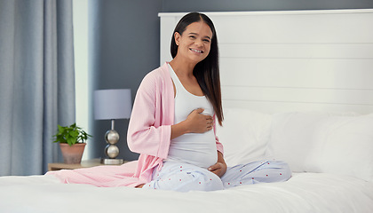 Image showing Pregnant woman, portrait and stomach in home bedroom happy about bonding and growth. Mother to be person with hands on abdomen for healthy pregnancy development, body wellness and love or care on bed