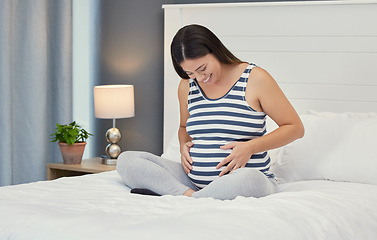Image showing Pregnant stomach, woman and home bedroom while happy about bonding and growth. Mother to be person with hands on abdomen for healthy pregnancy development, body wellness and care or love on her bed