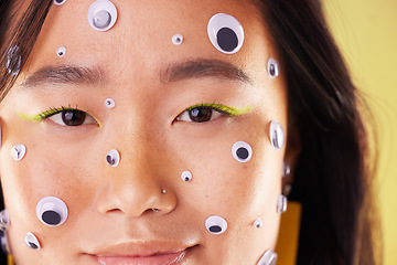 Image showing Gen z, eyes sticker art and portrait of an Asian woman with makeup and colorful cosmetics. Creative googly eye application, style influencer and cosmetic creativity of a model with studio background