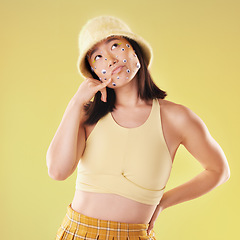 Image showing Fashion and woman with a hand call isolated on a yellow background in a studio. Idea, thinking and Asian girl with fingers in a telephone gesture for communication, conversation and talking