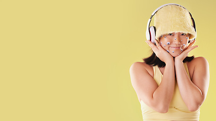 Image showing Fashion, music headphones and woman portrait with mockup space isolated on yellow background. Face of a happy asian girl model with tech for listening to audio, sound or podcast advertising in studio