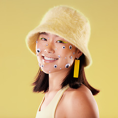 Image showing Fashion, face and woman portrait with comic eyes isolated on yellow background in a studio. Happy, funny and stylish asian girl model with a smile, color and mindset for motivation and skin cosmetics