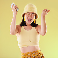 Image showing Phone, wow and celebration of woman in studio isolated on a yellow background. Excited winner, surprise and happy female with mobile smartphone celebrating after winning success, good news or lottery