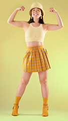 Image showing Smile, empowerment and asian woman flexing arms, full body portrait of gen z model with trendy fashion win in studio. Feminism, power and strength, happy and strong girl isolated on yellow background