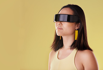 Image showing Vr, 3d metaverse and woman in virtual reality, exploring cyber space or futuristic tech mockup. Fantasy, gamer and female with digital ai glasses for gaming in studio isolated on a yellow background
