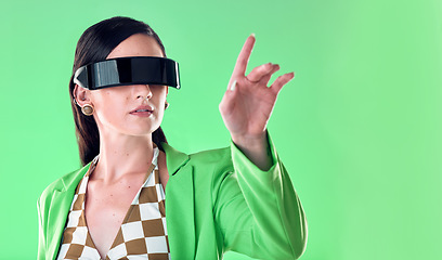 Image showing Woman, virtual reality and glasses in studio with hand by green backdrop, background and gaming online. Young model, aesthetic and ideas with vr, esport and fashion with analytics, ux and metaverse