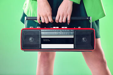 Image showing Radio, woman and music with retro technology and fashion, entertainment with station, funk and hands on green background. Style, vintage sound and audio equipment, female model with broadcast device