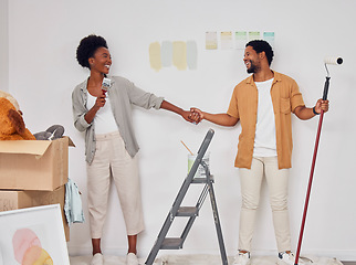 Image showing Painting, holding hands or black couple singing in DIY, home renovation or remodel together with paintbrush. Playing, smile or fun African man laughing with happy woman dancing in house with teamwork