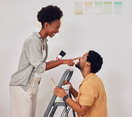 Image showing Painting, ladder or funny black couple in DIY, home renovation or house remodel together with paintbrush. Playing, smile or African man laughing with happy woman working with teamwork in partnership