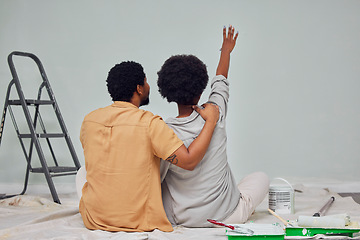 Image showing Painting, wall or black couple planning DIY, home renovation or house remodel together on floor. Back view, pointing or African man loves speaking to young woman working with teamwork in partnership