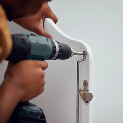 Image showing Building, construction and hands of a person with a drill for a baby bed for preparation in a house. Metal, maintenance and man with a mechanical tool to build a frame for a child to sleep in a home