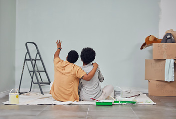 Image showing Planning, wall or black couple pointing in home renovation, diy or house remodel together on floor. Back view, painting or African man loves talking or working with teamwork in decoration with woman
