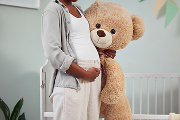 Image showing Pregnant, teddy bear and woman with hand on stomach for growth, development and bonding in room. Black person during pregnancy with stuffed animal toy for care, love and support for healthy lifestyle