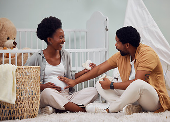 Image showing Love, pregnant and black couple in bedroom, excited and celebration on floor, happiness and conversation. Pregnancy, man and woman with smile, stomach and family in home, wow and talking in house