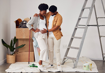 Image showing Painting, pregnancy or black couple hug in home renovation, diy or house remodel together by apartment ladder. Teamwork, people or African man and pregnant woman excited about baby or new family