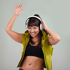 Image showing Punk, dance and woman with headphones, celebration and music streaming against grey studio background. Hipster, female and happy lady with headset, smile or sounds with trendy, stylish or edgy outfit