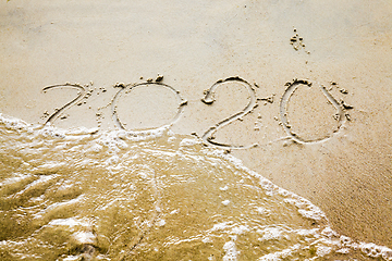 Image showing sea waves erasing the inscription of 2020