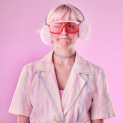 Image showing Fashion, gen z and woman in a studio with trendy glasses, earmuffs and outfit with style. Edgy, beauty and female model with cool clothes and a confused face expression isolated by a pink background.