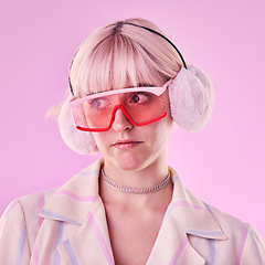 Image showing Woman, fashion and unique on a pink background in studio with funny glasses for cyberpunk style. Face of edgy, trendy or retro aesthetic person thinking vaporwave, creativity and art color clothes