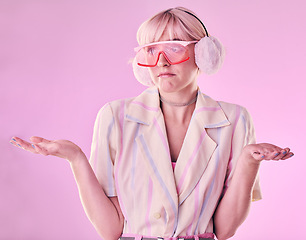 Image showing Confused, question and woman shrugging shoulders with fashion, why and isolated in a studio pink background. Cool, model and female stylist with doubt, dont know hopeless gesture with mockup