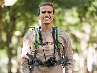 Image showing Hiking photographer, portrait and man in forest for backpack adventure, research or excited trekking journey. Hiker, young person or nature journalist vision for photography, creative and tourism