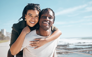 Image showing Bonding couple, portrait or piggyback by beach, ocean or sea in relax mock up holiday, love vacation or summer travel. Smile, happy or man carrying black woman in fun game, freedom trust or support