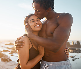 Image showing Couple hug or forehead kiss on sunset beach in relax romance holiday, love vacation date or bonding summer. Smile, black woman or kissing man in swimwear embrace, trust or travel support by ocean sea