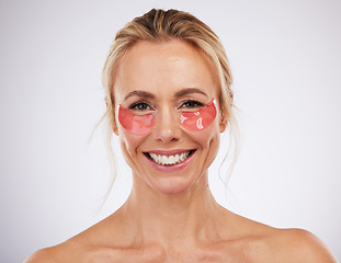 Image showing Skincare, eye pads and woman in studio with beauty, self care and natural face treatment. Cosmetic, dermatology and portrait of mature female model with anti aging facial treatment by gray background