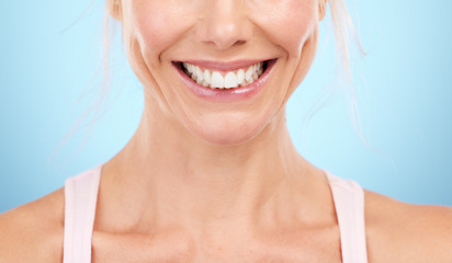 Image showing Smile, teeth whitening and woman mouth in studio, blue background and facial wellness. Closeup female model, clean dental and happy face of fresh breath, tooth implant and healthy aesthetic beauty