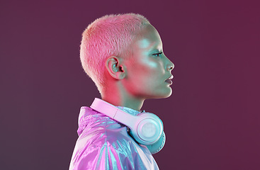 Image showing Cyberpunk headphones, black woman and fashion in studio, holographic beauty and vaporwave clothes. Futuristic model, young gen z and listening to music with neon aesthetic, audio technology and face