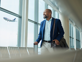 Image showing Black man, business and travel at airport on airplane for professional trip, journey or flight. Happy manager walking with suitcase, luggage and bag for boarding, check in or smile at terminal window