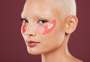 Image showing Portrait, eye mask and skincare with a model black woman in studio on a red background for beauty. Face, skin and antiaging with an attractive young female posing to promote a cosmetic product