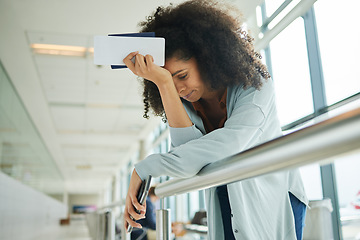 Image showing Travel, stress and black woman at airport with headache, issue and flight delay, frustrated and angry. Travelling, compliance and female with anxiety, trouble and missed departure alone at a terminal