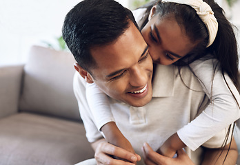 Image showing Family, hug and girl with father on sofa, happy and laugh, kiss and bonding in their home. Embrace, smile and parent with child on couch, play or enjoy day off, weekend or piggyback in a living room