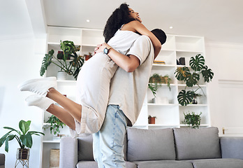 Image showing Young couple, hug and jump in new house, real estate and apartment lounge with love. Happy homeowners hugging to celebrate in living room, property investment and dance with care, energy or happiness