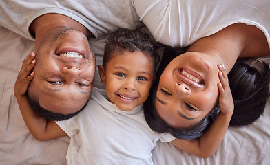 Image showing Above, portrait and happy family relax in bed, children and bonding in their home together. Love, face and boy with parents waking up in a bedroom, smile and resting on the weekend, cosy and content