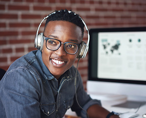 Image showing Headphones, happy and black man with a smile in office while listening to music, radio or podcast. Happiness, excited and African male employee a streaming song or playlist while working in workplace