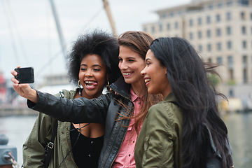 Image showing Selfie, travel or bonding with tourist friends taking a picture outdoor together in a foreign city abroad. Happy, smile or diversity with a group of women overseas on vacation posting on social media