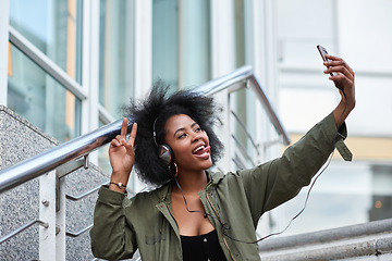 Image showing Selfie, campus and black woman student taking picture to update social media in a city with a peace sign or hand gesture. Photo, internet and young female making funny face with tongue online in town