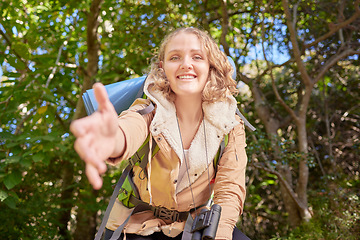 Image showing Woman hiking, nature portrait and helping hand pov with happiness, goal or outdoor adventure in summer. Happy hiker girl, free and smile in sunshine, woods or forest on walk with backpack on holiday