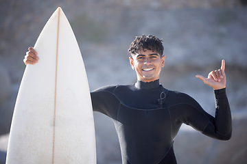 Image showing Surfer man, hand sign and portrait at beach, summer sports and freedom in sunshine. Surfing board, shaka and guy relax at ocean on adventure, sea travel and smile on holiday, vacation or fun in Miami