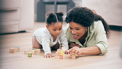 Image showing Baby, mother and toy building blocks for child knowledge development on living room floor. Family home, teaching and mom with girl toddler learning and helping with happiness and a smile with love