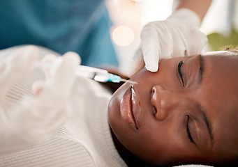 Image showing Face, syringe and skincare, black woman at spa with collagen injection for skincare and beauty treatment. Dermatology, cosmetics and person at salon with needle in skin for anti aging facial process.