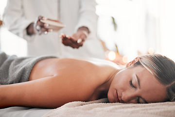 Image showing Spa, oil and woman on a table for massage, wellness and skin treatment for peace, zen and relax. Luxury, girl and masseuse with skin product for massaging, therapy and healing in a beauty salon