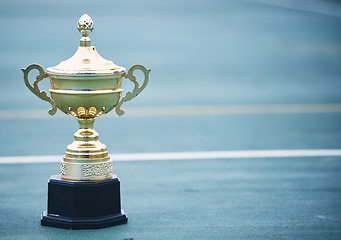 Image showing Sports, award and trophy on the floor with no people at court for success, winner or achievement. Prize, victory and sport reward on a ground at an empty stadium for sport, champion and competition