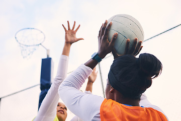Image showing Netball, goal shooter and fitness of a girl athlete group on an outdoor sports court. Aim, sport game and match challenge of a black person with a ball doing exercise and training in a competition